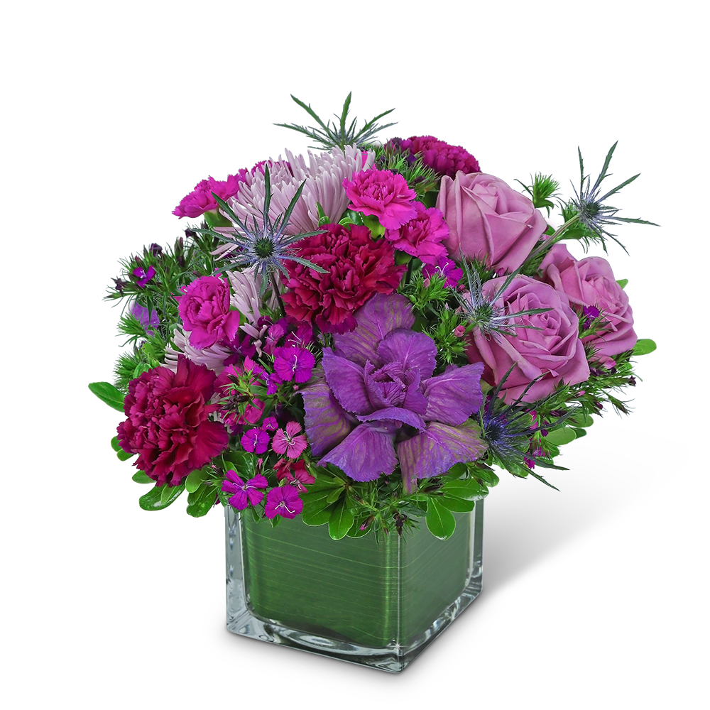 Purple and pink floral arrangement in a square glass vase
