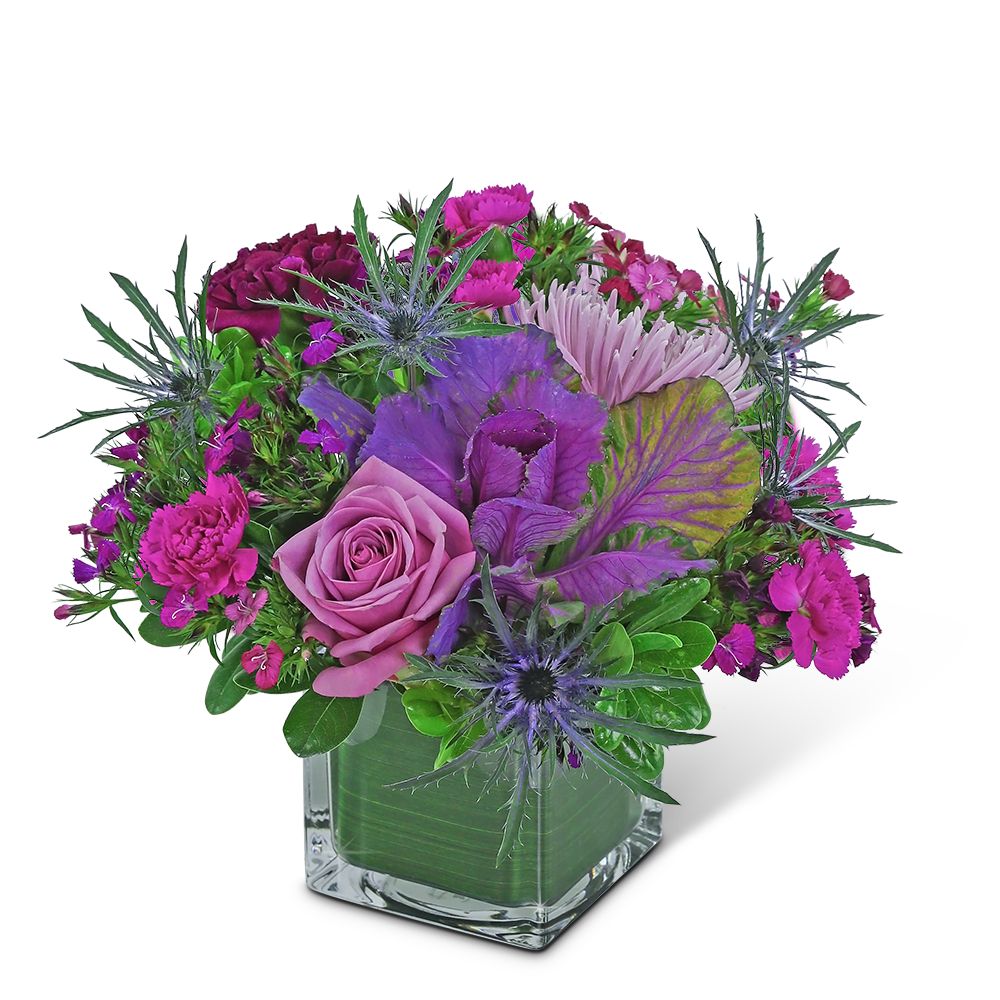 Pink and purple bouquet in a square glass vase