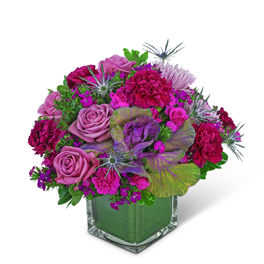 Pink and purple floral arrangement in a clear square vase