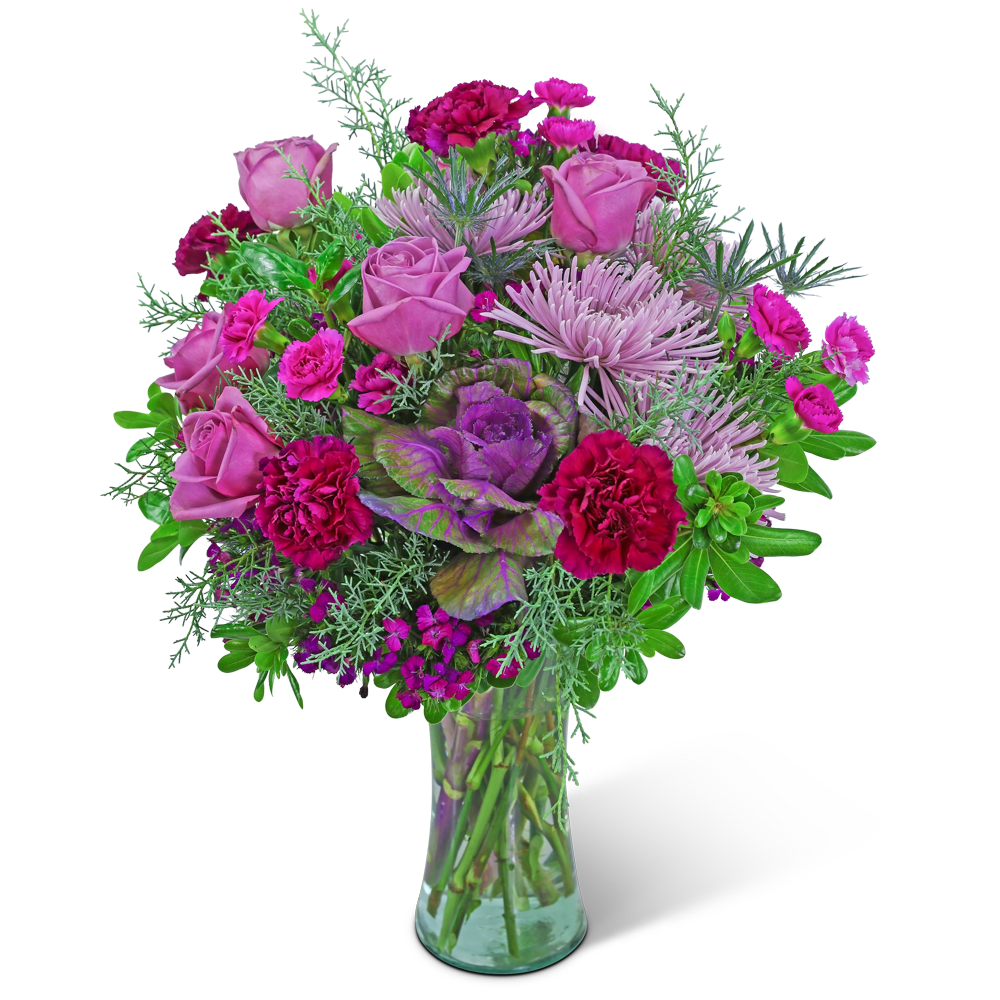 Pink and purple bouquet of roses, carnations, and chrysanthemums in a glass vase