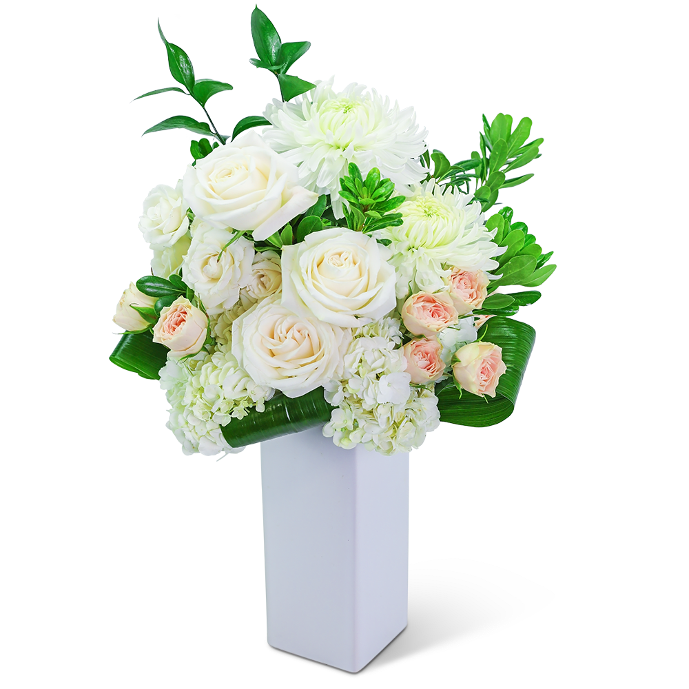 White roses and chrysanthemums in a tall white vase