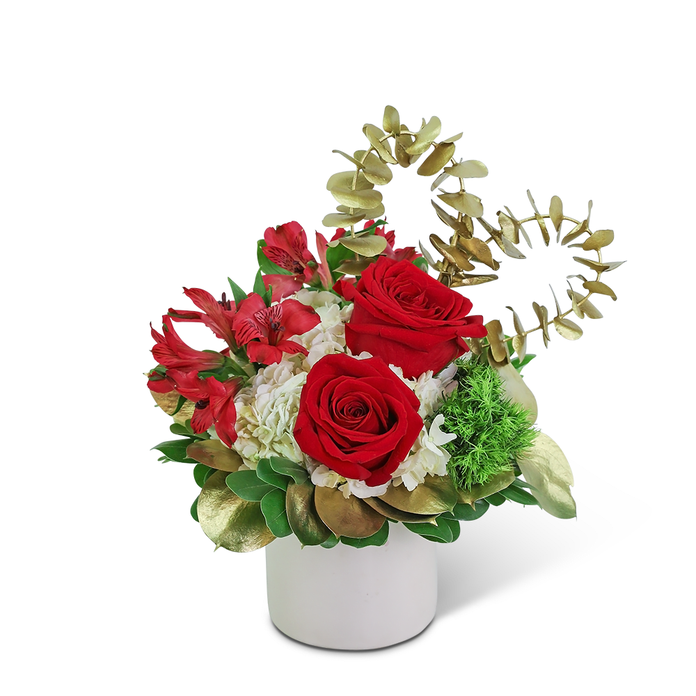 Red roses and red alstroemeria in a white vase with gold foliage