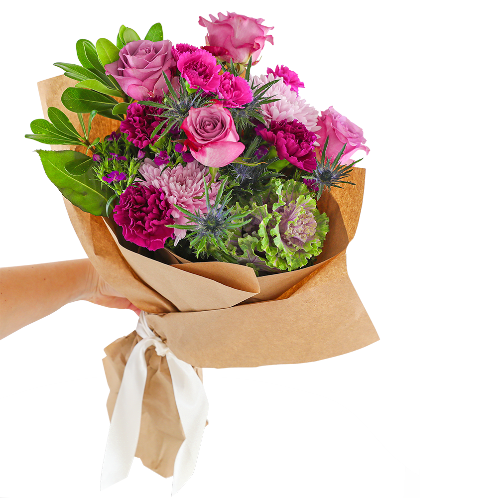 Hand-tied bouquet of pink and purple flowers wrapped in brown paper