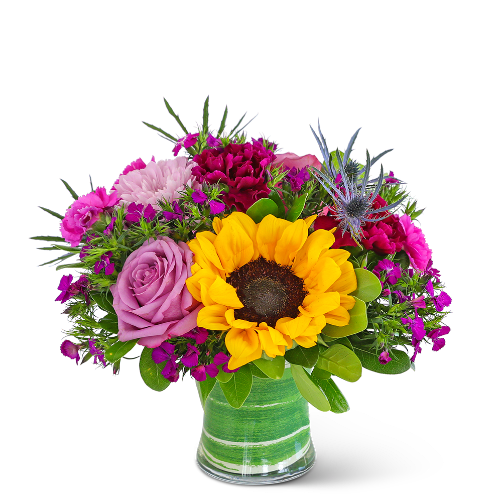 Bright mixed bouquet with a sunflower and pink roses in a green glass vase