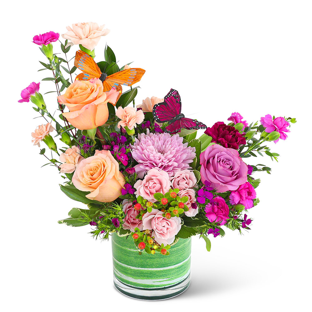 Flutters of Love - Our Flutters of Love flower design is a artful blend of Roses, Carnations, and Cremon Mums, with beautiful complementary foliage in a leaf-lined vase. The accent of butterflies make it the ideal spring flower arrangement. These soft peach and pastel flowers mixed with the bold purple blooms make this the perfect gift for Mother's Day, a birthday, or just because. Send these gorgeous flowers to someone special and you'll make their whole week!