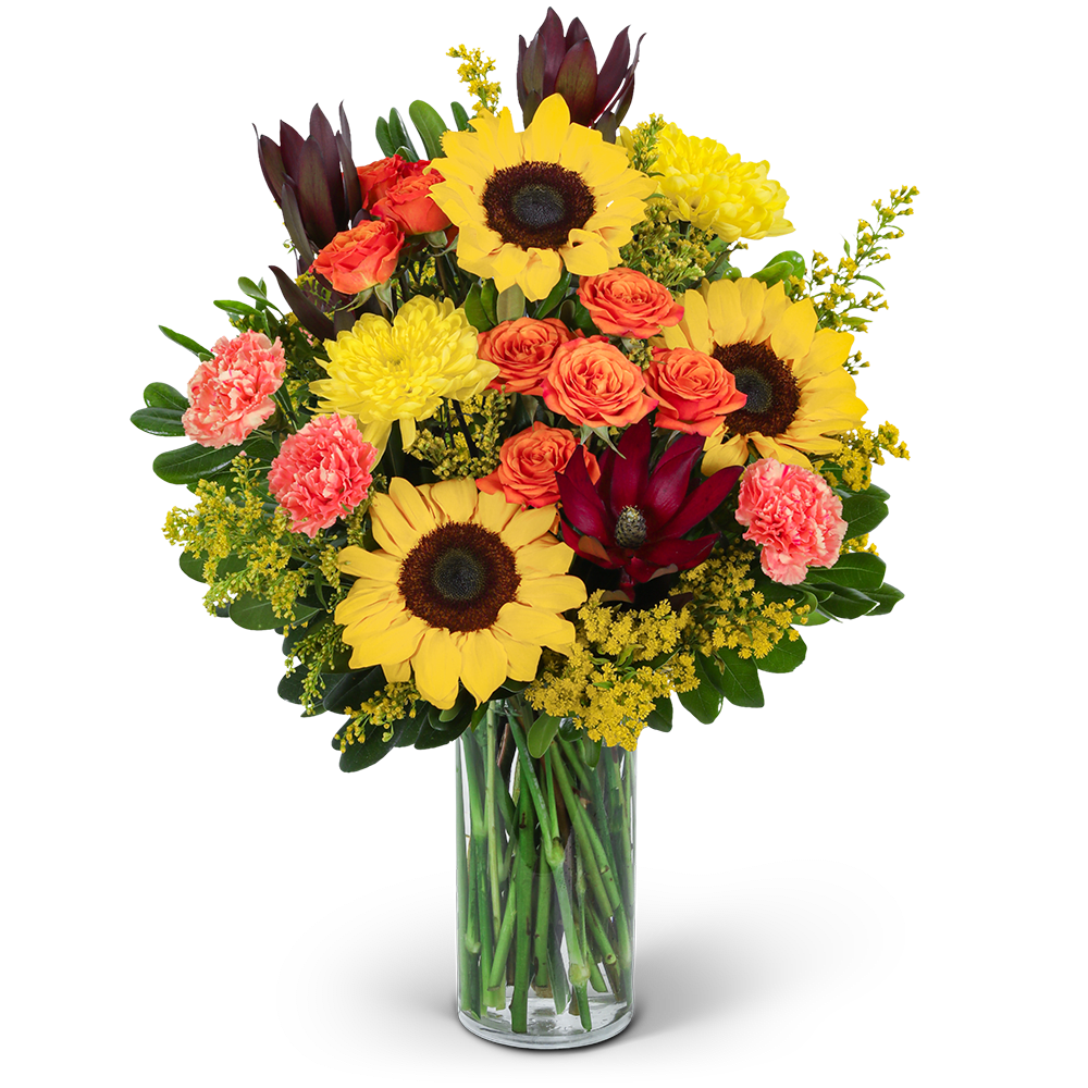 Sunflowers, orange roses, and pink carnations in a glass vase