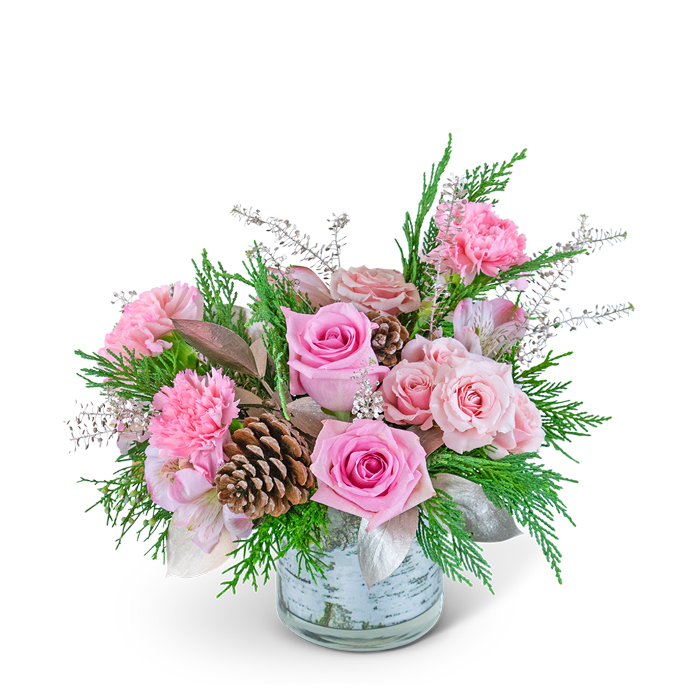 Pink roses and carnations in a glass vase with pinecones