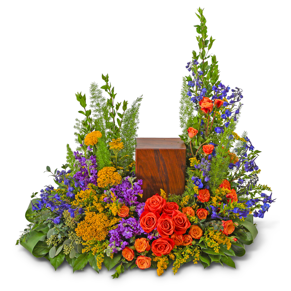 Large floral arrangement with red roses, purple flowers, and yellow accents around a wooden urn