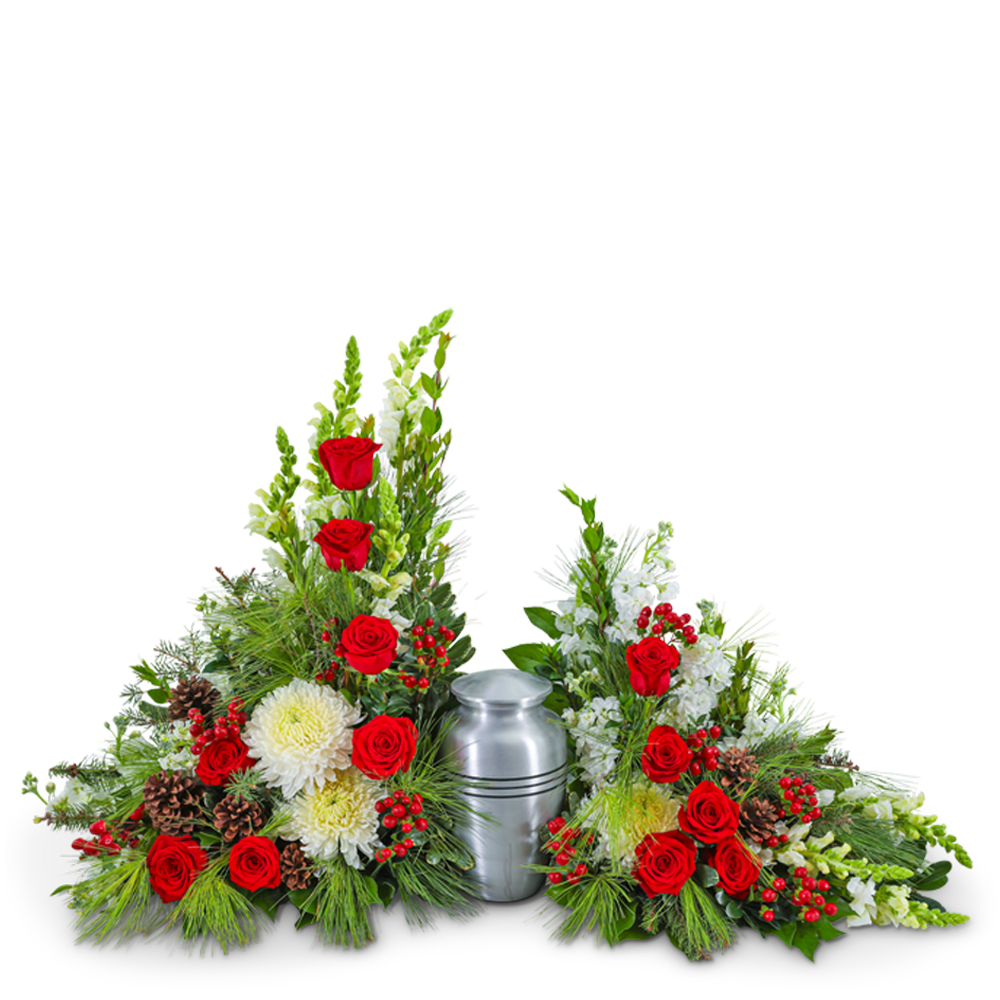 Sympathy urn arrangement with red roses, white flowers, and pinecones around a silver urn