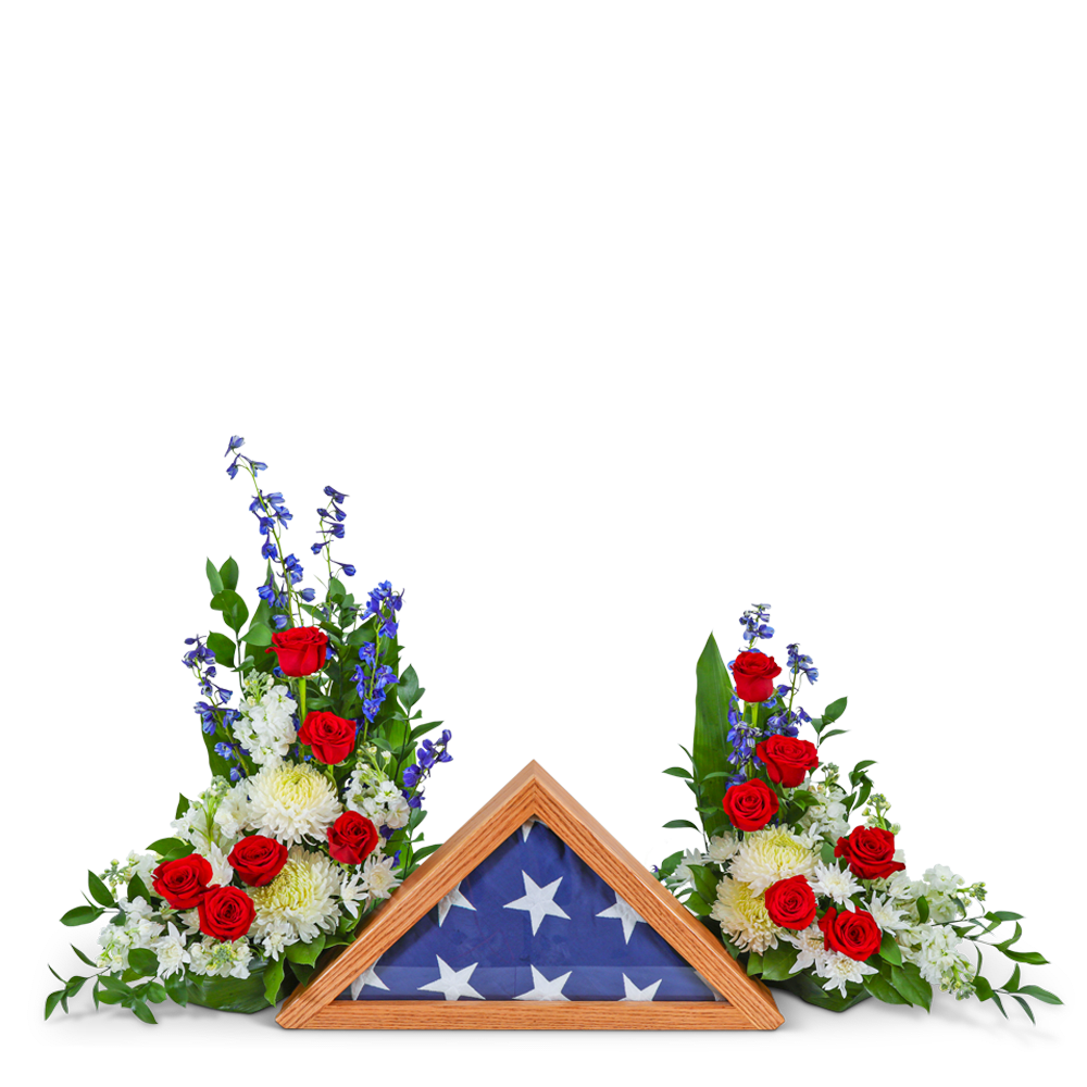 Final Salute Memorial Tribute - Our Final Salute Memorial Tribute is a popular choice for the funeral or celebration of life ceremony for the patriot you are honoring. Sympathy flowers for a veteran are beautifully shown in red, white, and blue funeral flowers. This patriotic theme is beautifully accomplished with two individual designs featuring a combination of Roses, Stock, Delphinium, Mums, Aspidistra, and other premium foliage. They come together to make a truly honorable tribute for your loved one who fought for our freedom. The flag is not included but is featured to show the unique personalization of adding a family keepsake to the design.