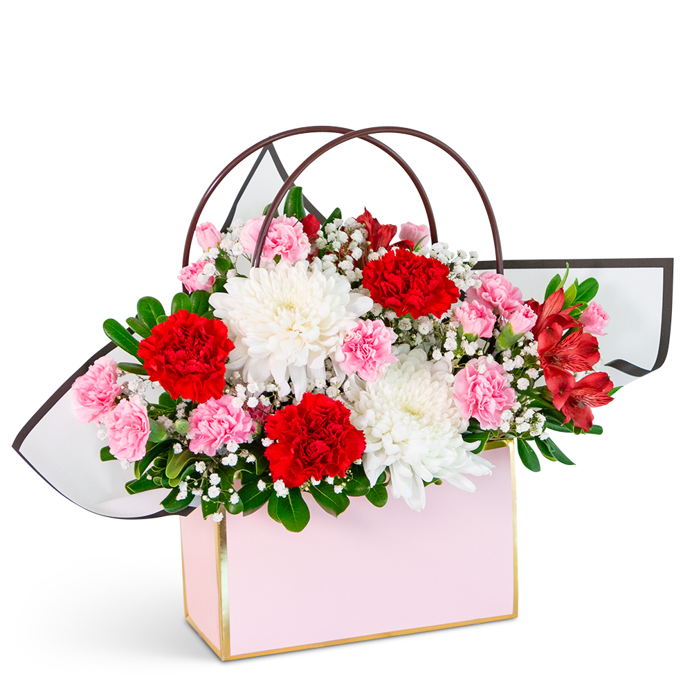 Pretty Posy Tote - Our Pretty Posy Tote is a charming mix of pinks and whites in a delightful flower arrangement sure to brighten someone's day. Our dedication to quality ensures a stunning display, with possible variations from the flowers depicted. Housed in a stylish Flower gift tote bag, this captivating arrangement will not only add a touch of beauty to the recipient's day but also offer easy transport and delivery for a thoughtful and convenient gift-giving experience.