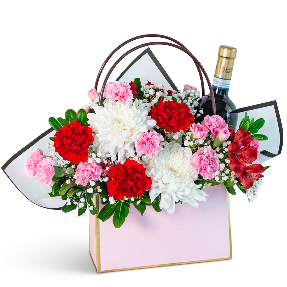 Flower gift basket with carnations, chrysanthemums, and a wine bottle