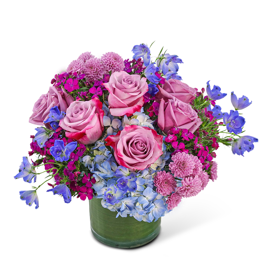 Indigo Illusion - Indigo Illusion is a beautiful floral design featuring Roses, Hydrangea, Button Spray Mums, Dianthus, Delphinium, and premium foliage in a leaf-lined vase. With shades of blue and purple, this enchanting design adds a touch of magic to any space or event, perfect for those seeking a unique birthday or anniversary gift.
