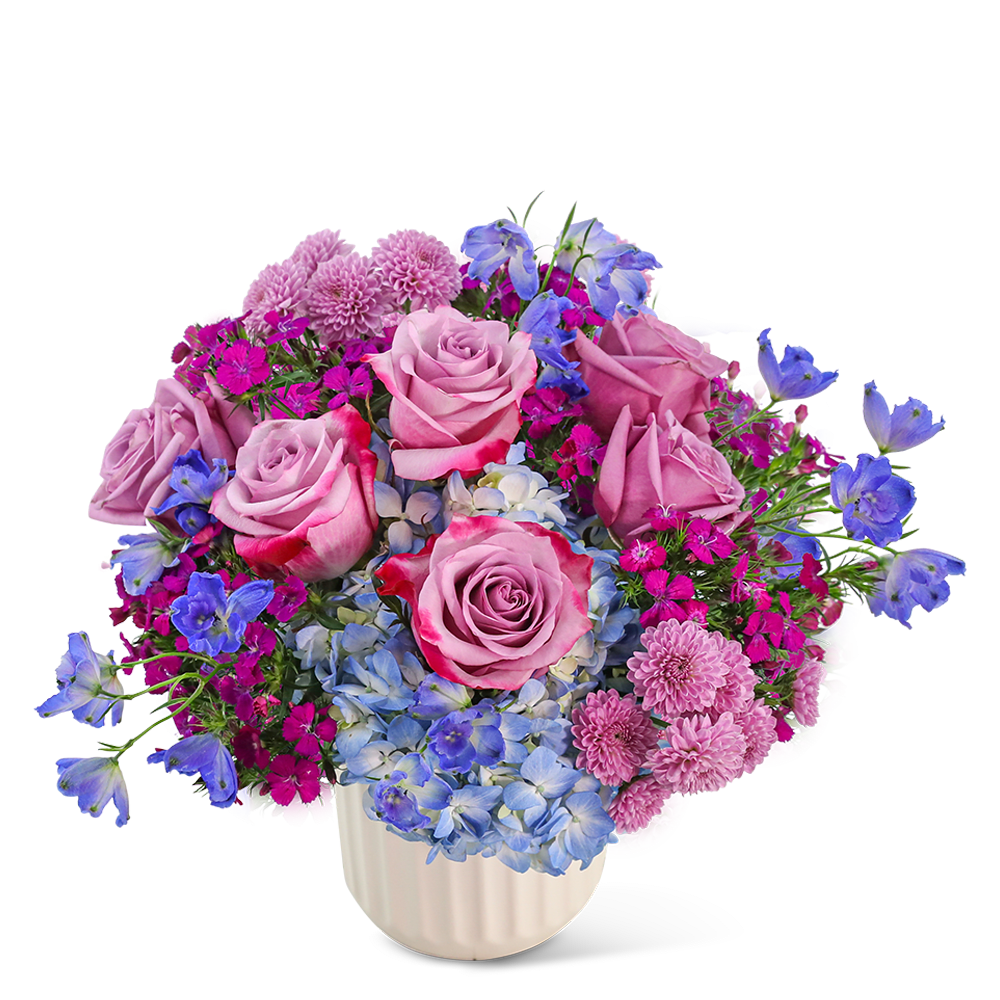 Pink roses and blue flowers arranged in a white vase