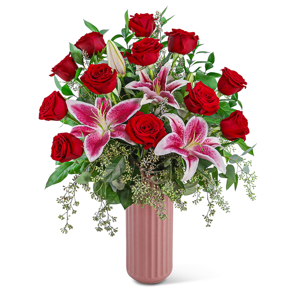 Red roses and pink lilies in a tall pink vase