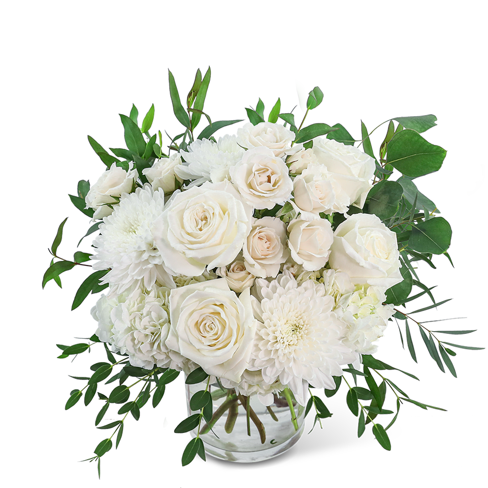 White roses and chrysanthemums in a clear glass vase