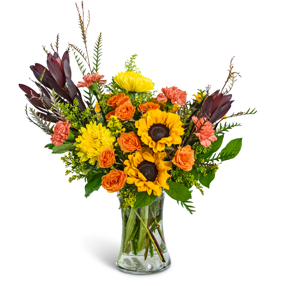 Bouquet of sunflowers, orange roses, and pink carnations in a glass vase