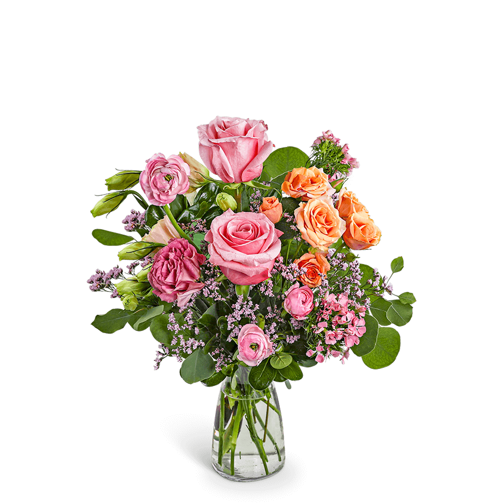 Pink and orange rose bouquet in a clear glass vase