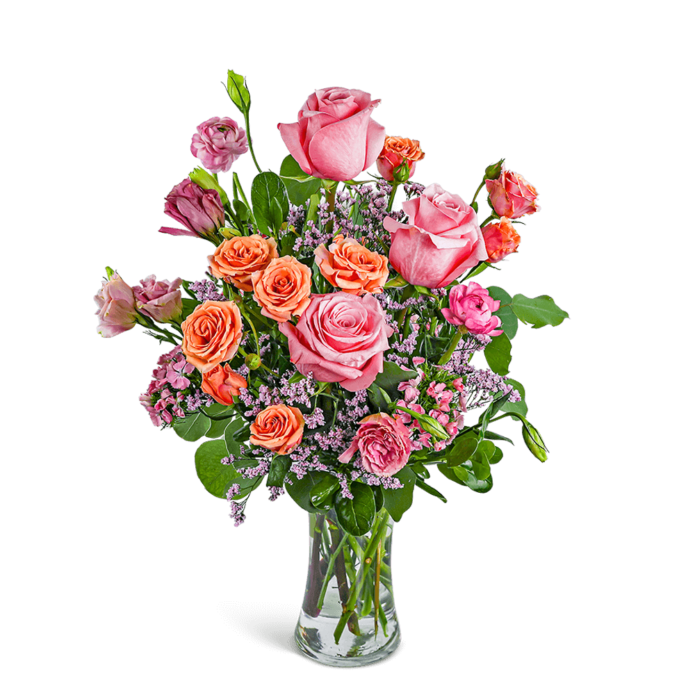 Pink and orange roses in a clear glass vase