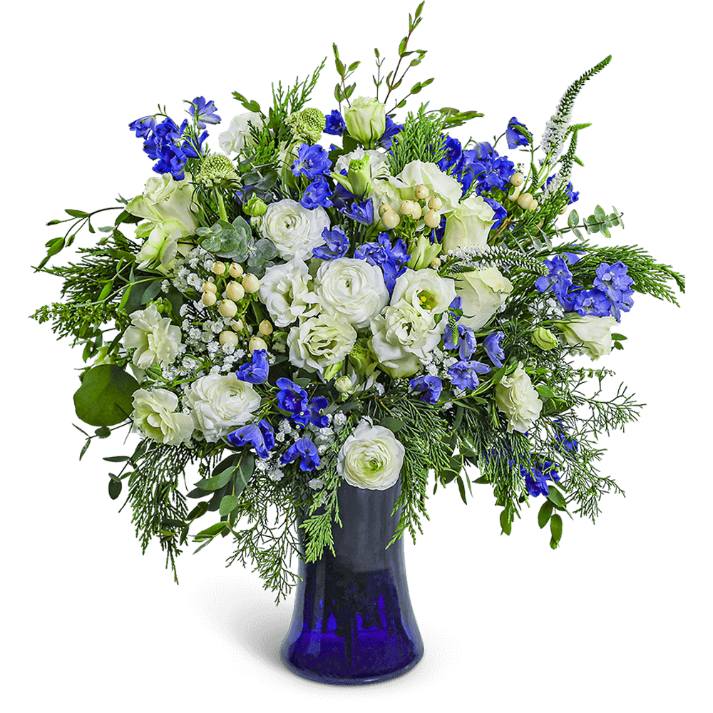 White and blue floral arrangement in a cobalt glass vase
