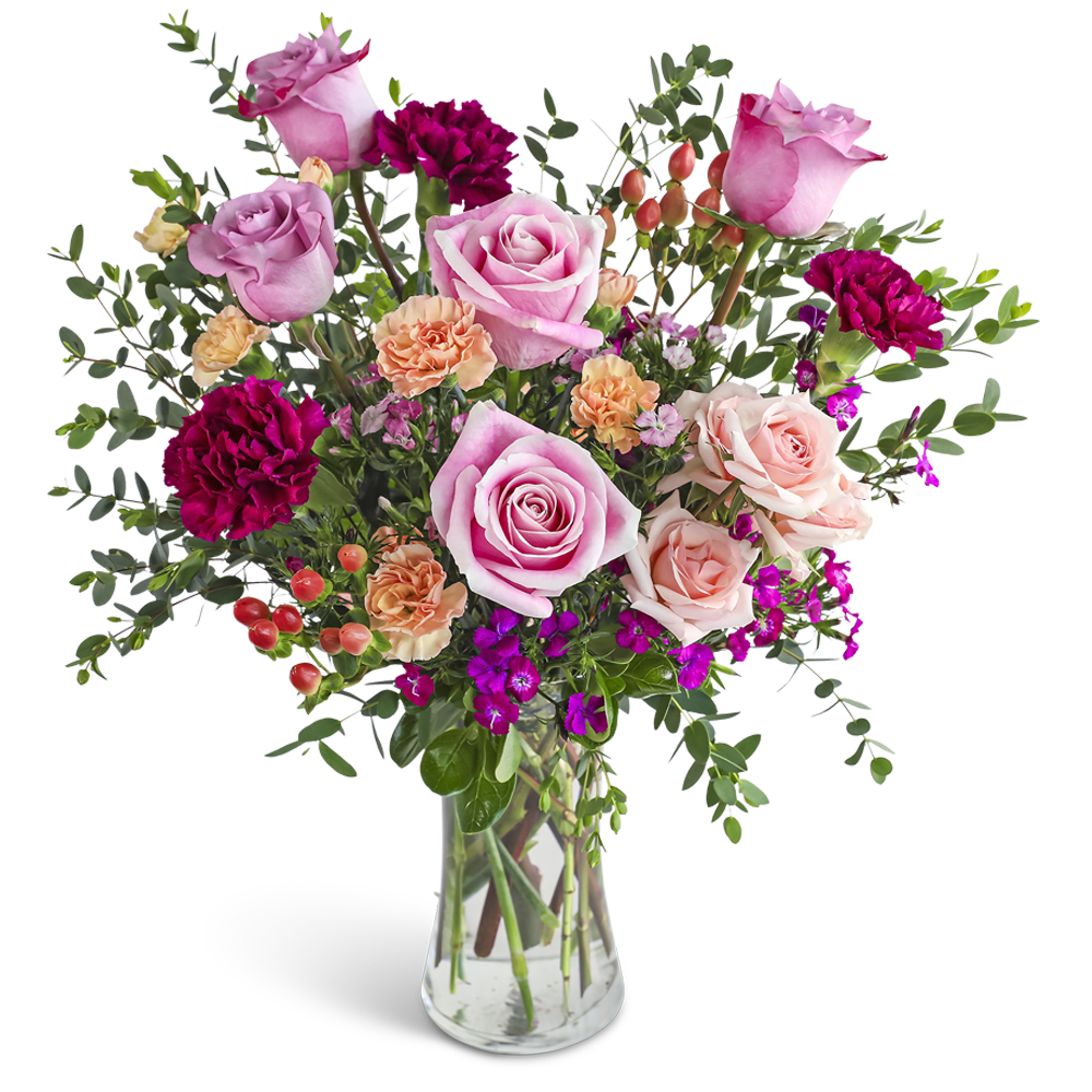 Tall glass vase of pink roses, peach carnations, and dark magenta blooms with berries.