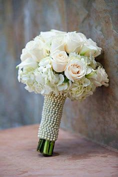 White rose and hydrangea bouquet with a pearl-wrapped handle