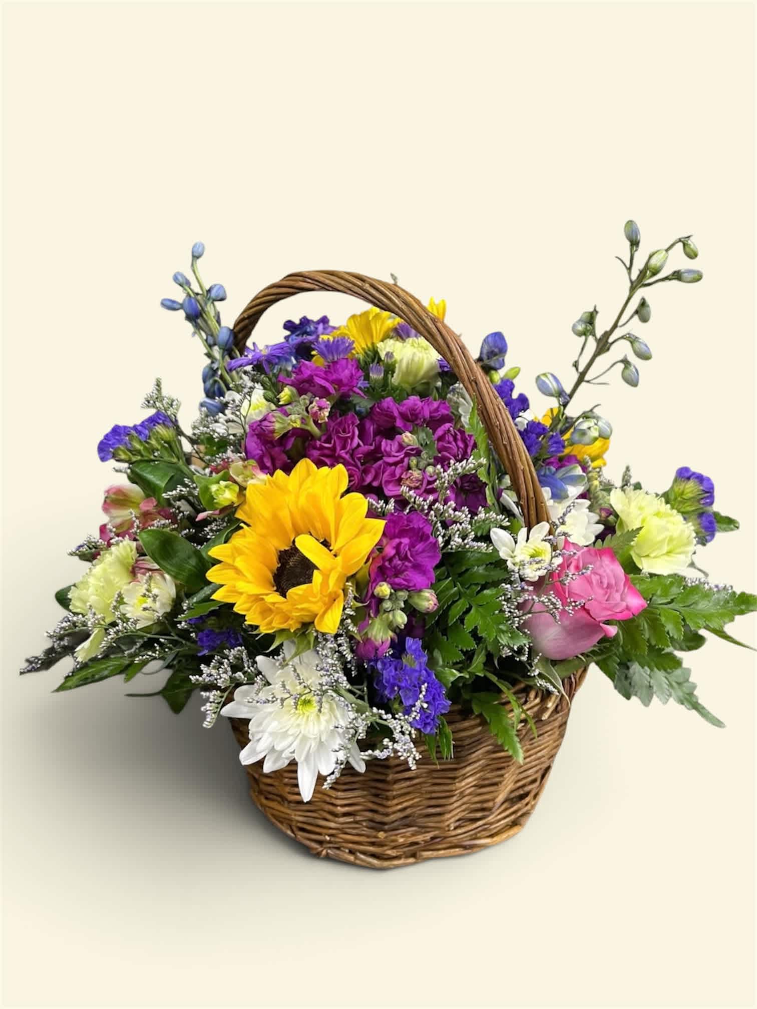 Mixed flower basket with a sunflower, roses, and daisies