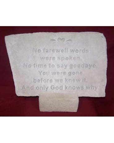 White memorial plaque with an engraved sympathy message on a red background