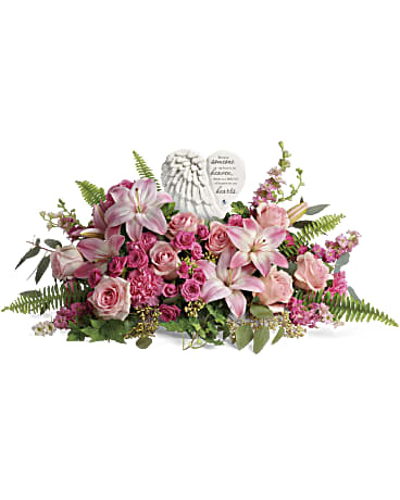 Pink floral arrangement with a heart-shaped memorial plaque