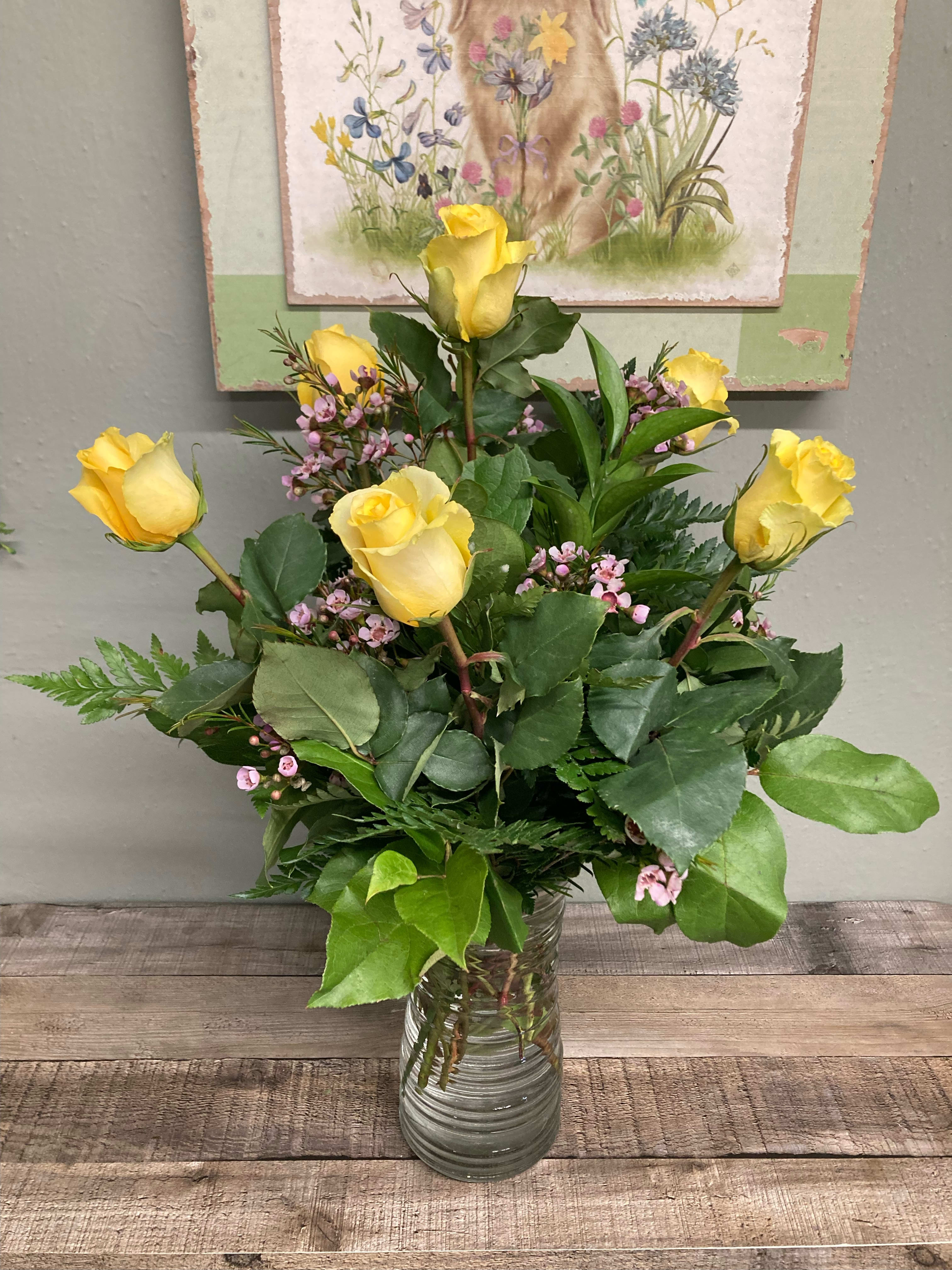 Half Dozen Yellow Roses - A half dozen yellow roses. Six bright yellow roses with filler and greenery in a clear glass vase . 