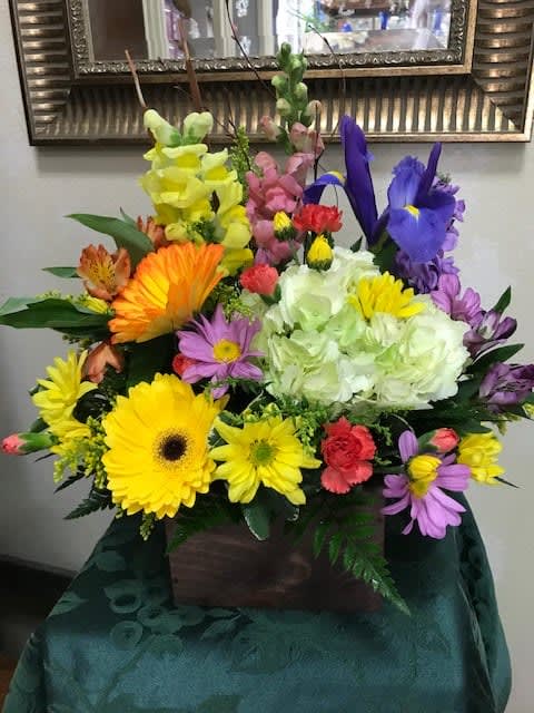 Colorful mixed flower arrangement in a wooden box