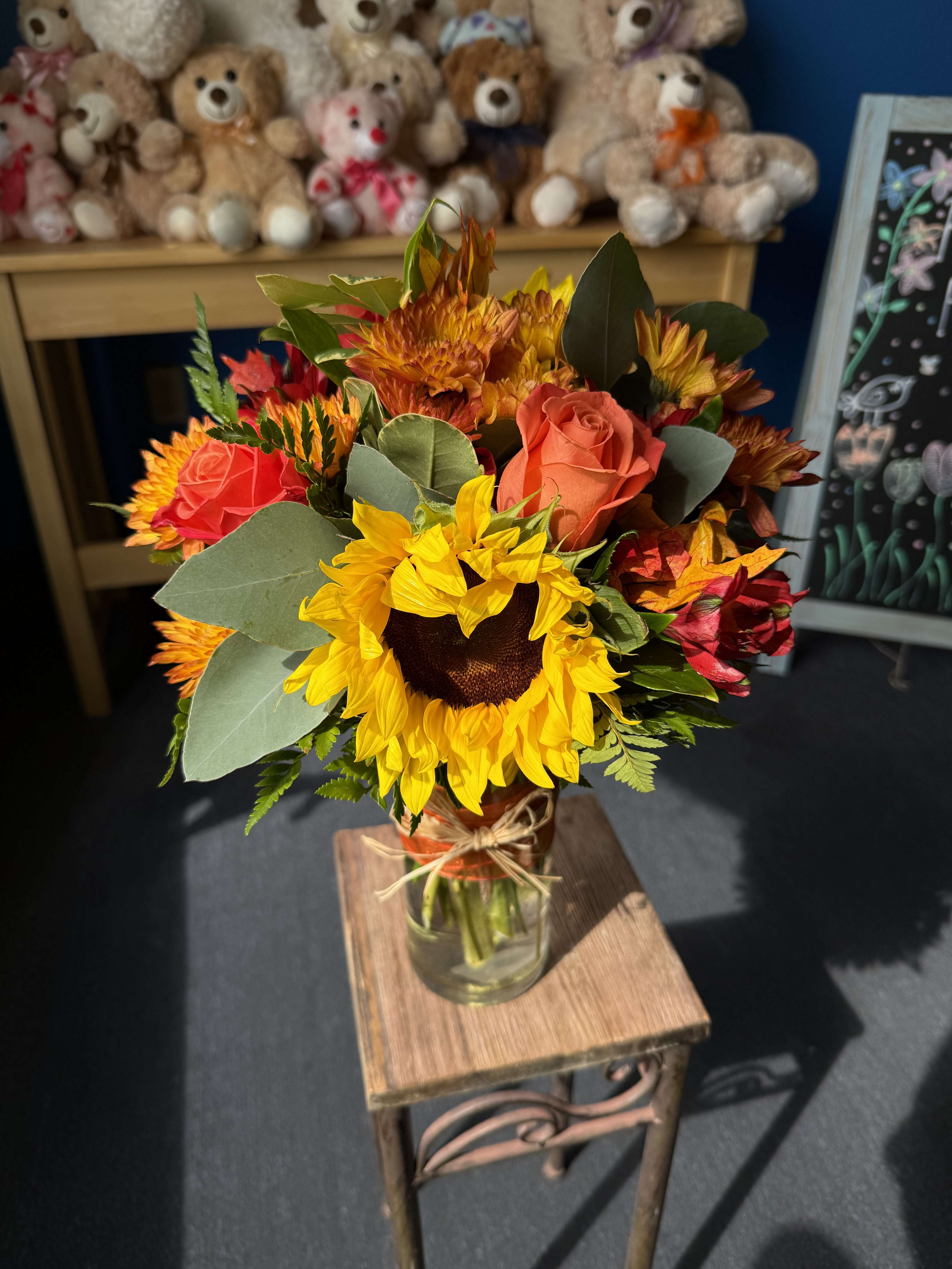 Sunflower and rose bouquet in a glass vase