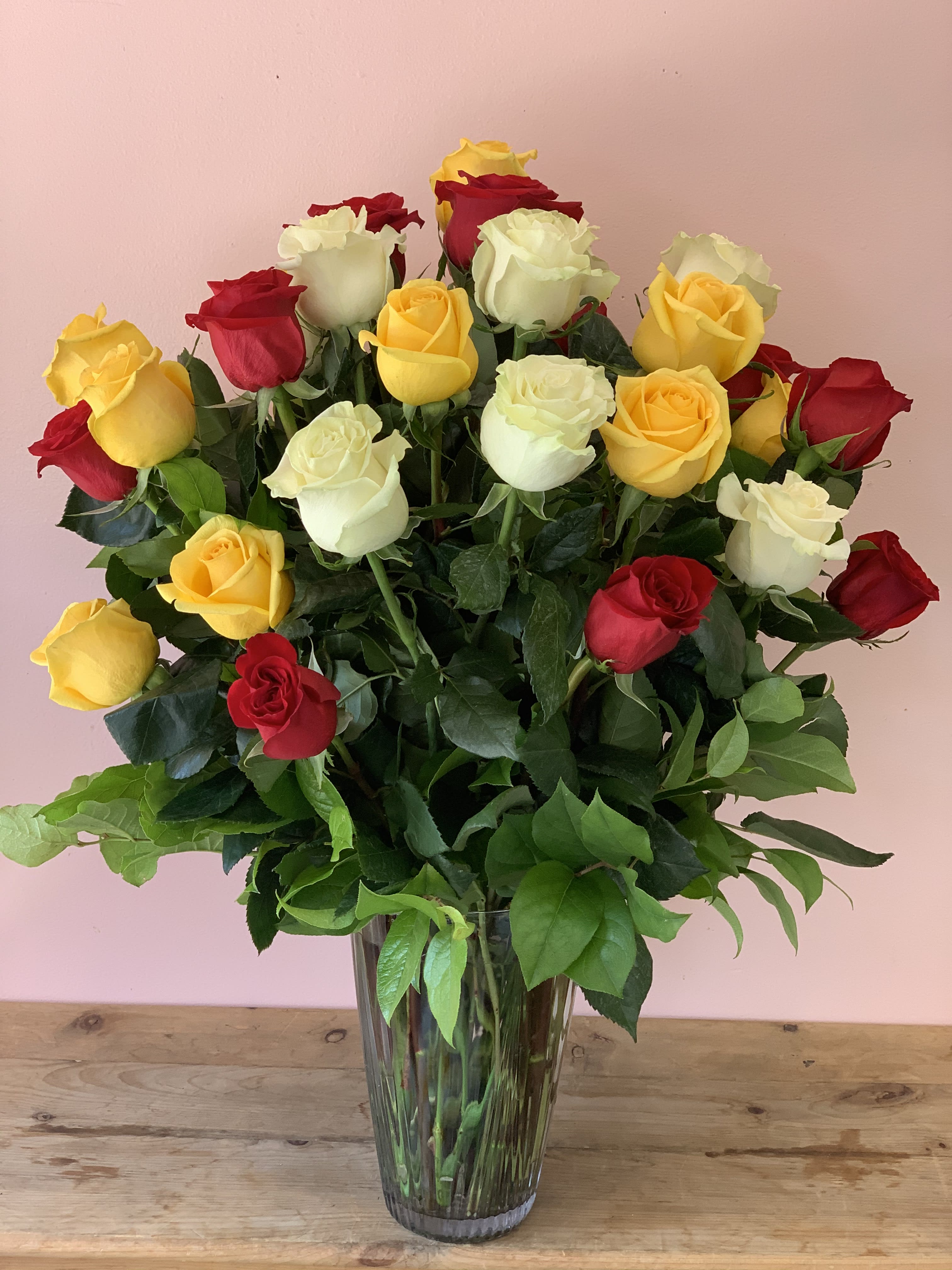 3  Dozen Multi-Colored Roses - W811 - A memorable mix of red , white, yellow roses for that unforgettable someone.Three dozen long-stemmed multi-colored roses accompanied by beautiful green foliage in a striking glass vase. Approximately 21" W x 23" H Orientation: One-Sided As Shown : W811