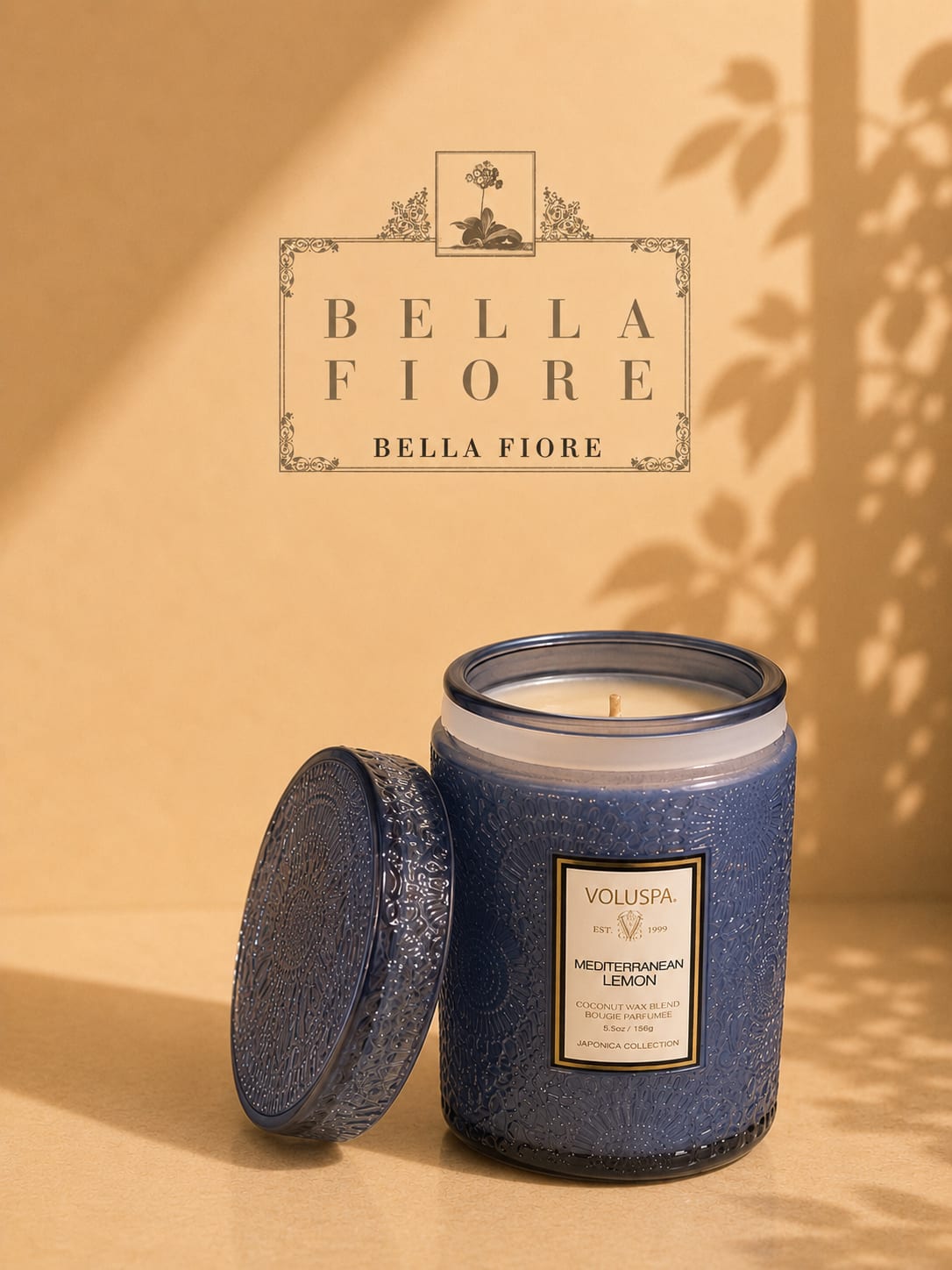 Blue scented candle in a decorative glass jar with lid