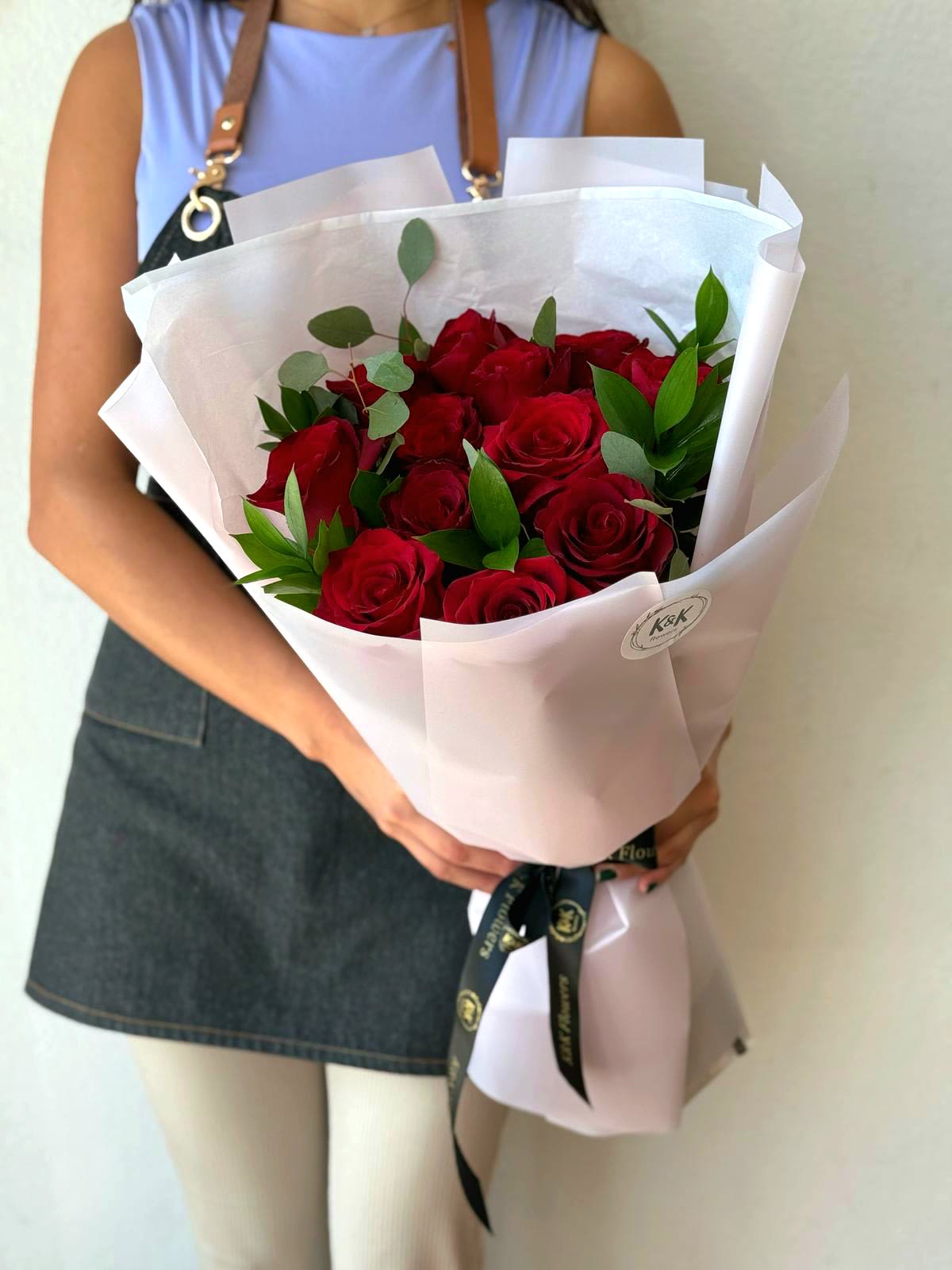 Bouquet of red roses wrapped in white paper