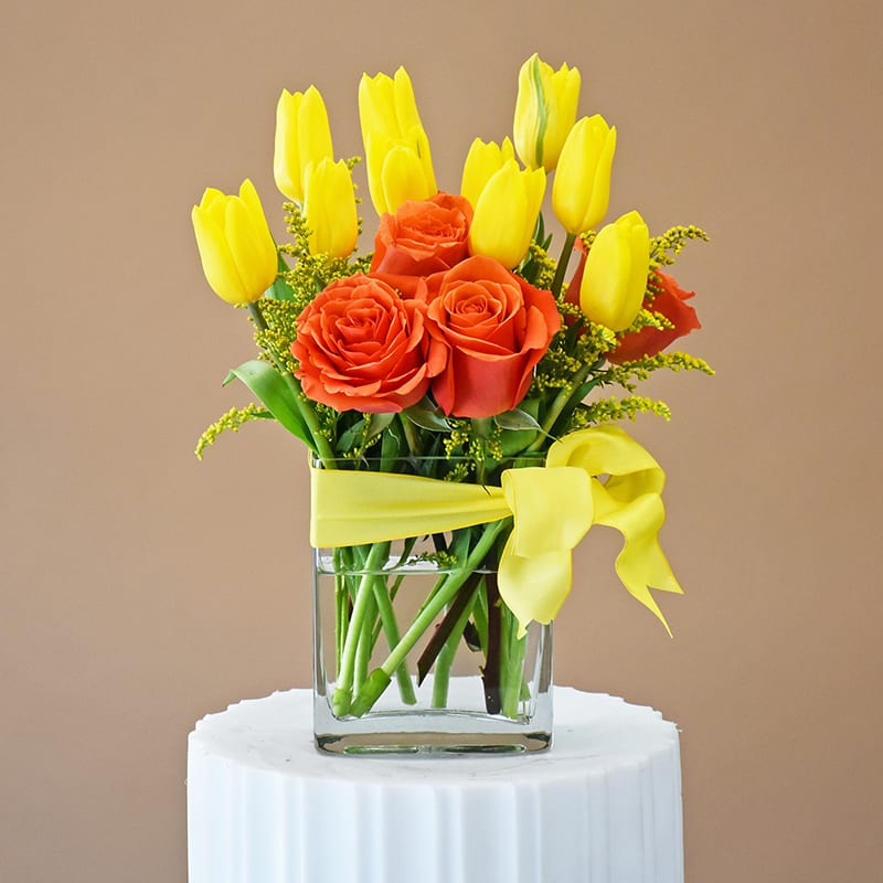 Tulips, Roses together - W620 - Yellow tulips and orange roses in rectangle clear glass vase wrapped  with yellow bow. Dimension approximetry 10"x 7" W620 
