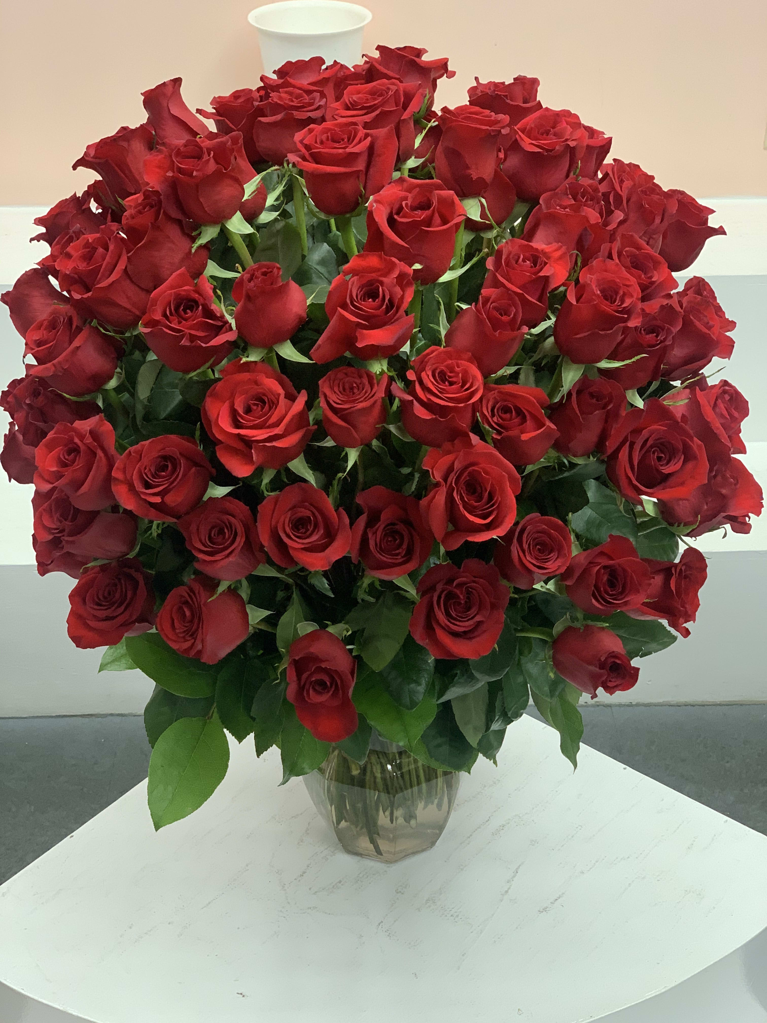 Large bouquet of red roses in a clear glass vase
