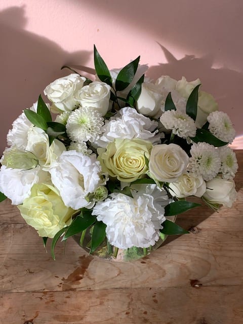 White roses and chrysanthemums arranged in a low bouquet