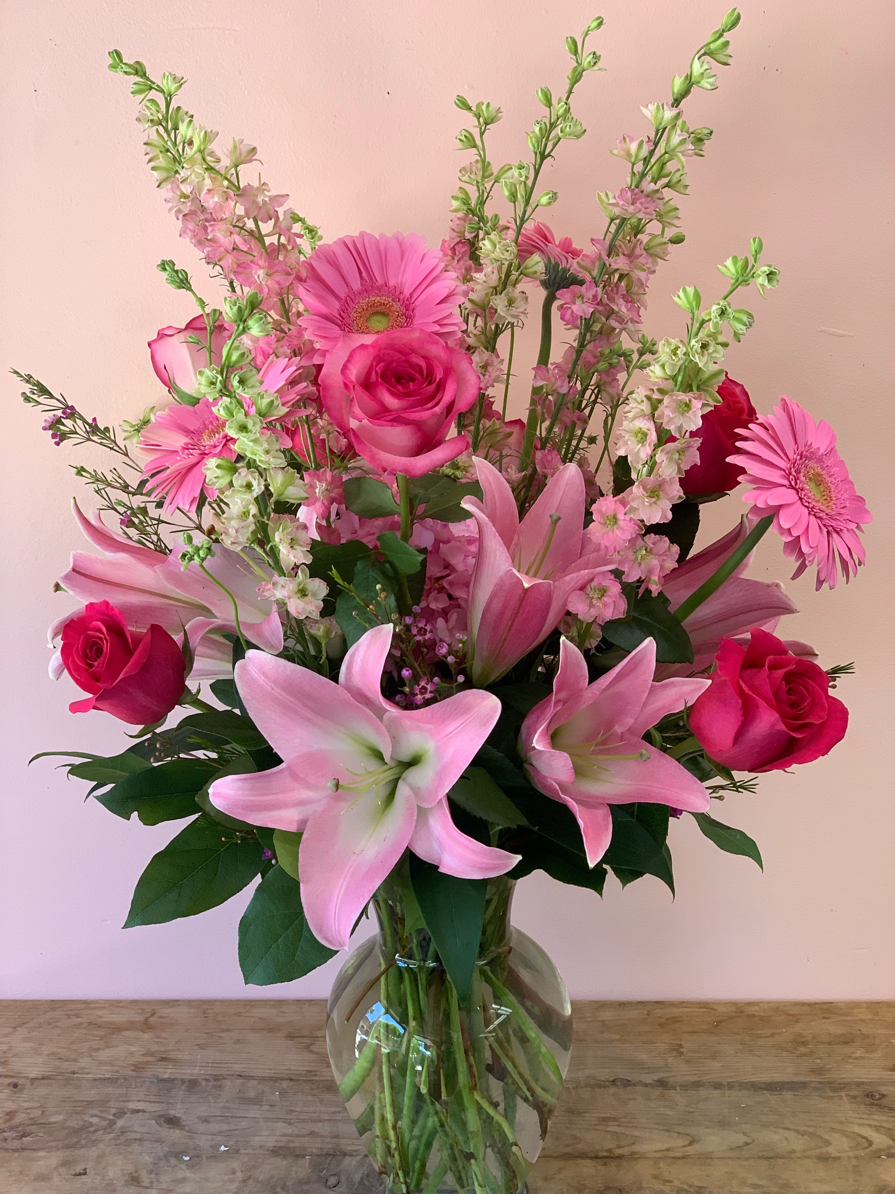 Rosy Maple Butterfly Flowers by Fillmore Florist in San Francisco - Sometimes, for some occasions, it is just appropriate and easier for us to convey our sentiments with flowers. Just by looking through our flower arrangements, we are sure you’ll come across a beautiful bouquet of flowers that looks exactly like how you feel. That is if what you felt were presented in a flower arrangement or a garden. Display your feelings with Fillmore Florist’s Rosy Maple Butterfly Flowers. A prominent florist in San Francisco, Fillmore Florist has been proudly serving joy with flowers for over 25 years with 100% success rate flower delivery in San Francisco. Rosy Maple Butterfly Flowers, is available for delivery in San Francisco and or for pick up at Fillmore florist San Francisco, all year round. This beauty is a fragrant, bright all pink flower arrangement that’s sure to delight your recipient. Made with pink Lilies, pink Floyd hot pink roses, light pink roses, pink Gerbera daisies, wax (real) flowers, and pink larkspur in a clear glass vase. Call and order today for your San Francisco flower delivery, it's never been easier with Fillmore Florist’s experts!  Approximate Dimensions: 18” H x 11” W 