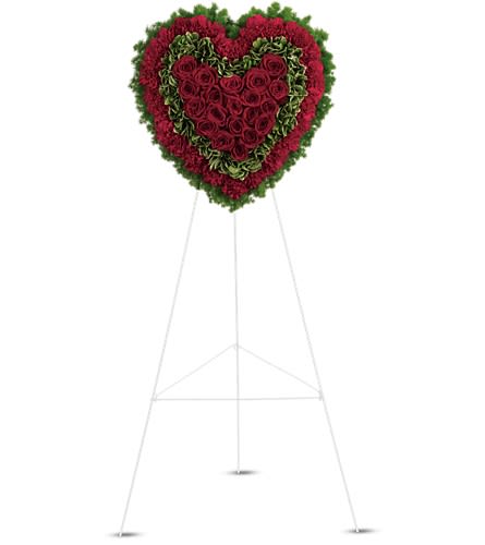 Heart-shaped standing floral tribute with red roses and green edging