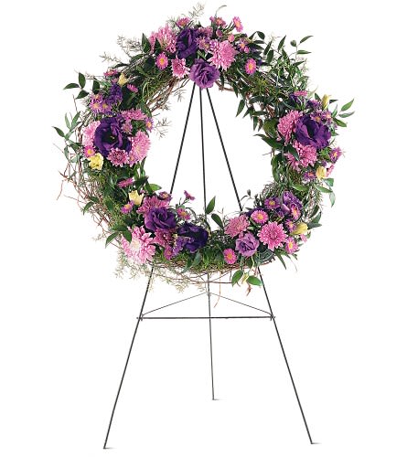 Grapevine Wreath - TF200-3 - This beautiful wreath with its purple and lavender chrysanthemums lisianthus and asters offers friends and loved ones all the hope you wish them. One wreath is covered with fresh greens and clusters of purple lavender and pink flowers and arrives on an easel.Approximately 26" D As Shown : TF200-3