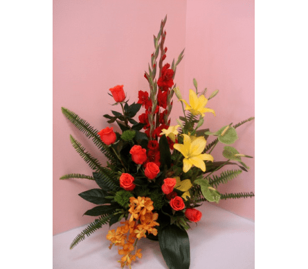 Gentle Force - W473 - Gentle Force is an exotic and tropical floral spray and is suitable for funeral and sympathy ceremonies. This floral spray is made with orange Rose Mokara Orchids red Gladiolus yellow Asiatic Lilies and green Anthuriums. Finally Gentle Force is garnished with an assortment of tropical greens.Dimensions Approximately: 25" H x 14" W As Shown : W473