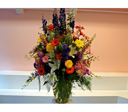 Paradise - W228 - Paradise is another one of Fillmore Florist's large floral arrangements. Make your special person the center of attention with an arrangement that's grand in both size and beauty. Made with Dendrobium Orchids Stargazer Lilies Larkspurs Mini Cymbidium Orchids Gerbera Daisies Roses Dahlia Lisianthus fancy greens in a large clear glass vase.Dimensions Approximately: 45" H x 20" W As Shown : W228
