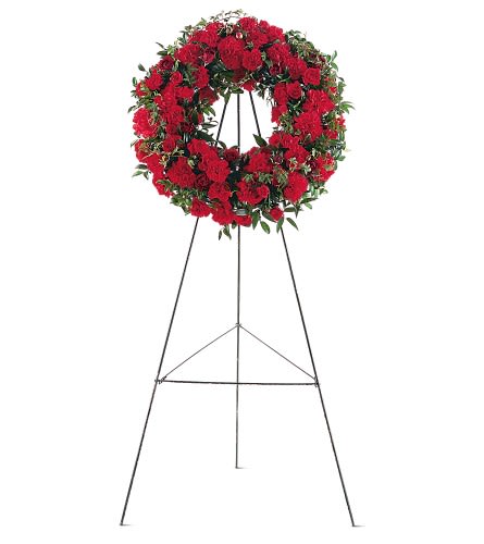 Red floral wreath on a metal easel stand