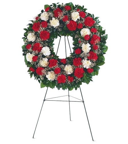 Red and white carnation wreath on a standing easel