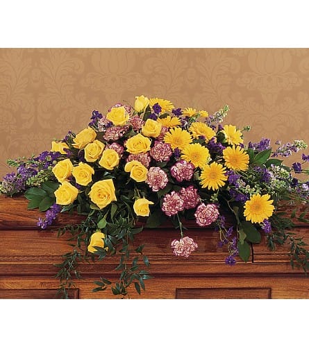 Casket spray with yellow roses, yellow daisies, and pink carnations