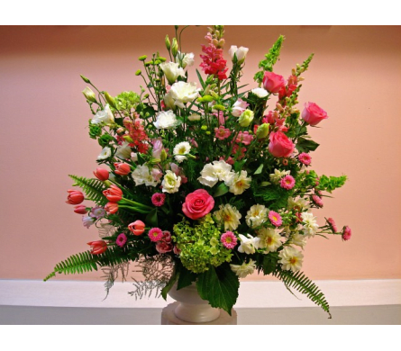 Essence of Nature - W239 - Essence of Nature is an arrangement that is suitable for all corporate events weddings and sympathy and funeral events. Made with Pink Snapdragon Tulips Roses Asters White Lisianthus Dahlias Asters green Bells of Irland green Hydrangeas and green Chrysanthemum Buttons in round container. Dimensions Approximately: 38"H x 22"W As Shown : W239
