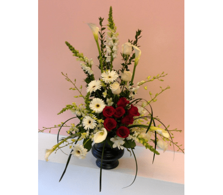 Attractive Floral Display - W422 - A very decorative and bold flower arrangement that's eye-catching and classy. Attractive Flora Display represents both passion and purity. This beauty is made with white Lilies Calla Lilies Dendrobium Orchids Gerbera Daisies Carnations Snapdragons Red Roses and Lily Grass in dark container or a wooden basket.Dimensions Approximately: 30" H x 16" W As Shown : W422