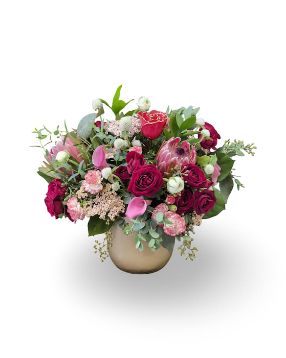 Forever Love - Forever Love is a lush, romantic arrangement featuring rich red and blush blooms, accented with greenery and a 24kt gold-dipped red rose designed to last forever. A timeless keepsake that pairs fresh beauty with lasting sentiment.