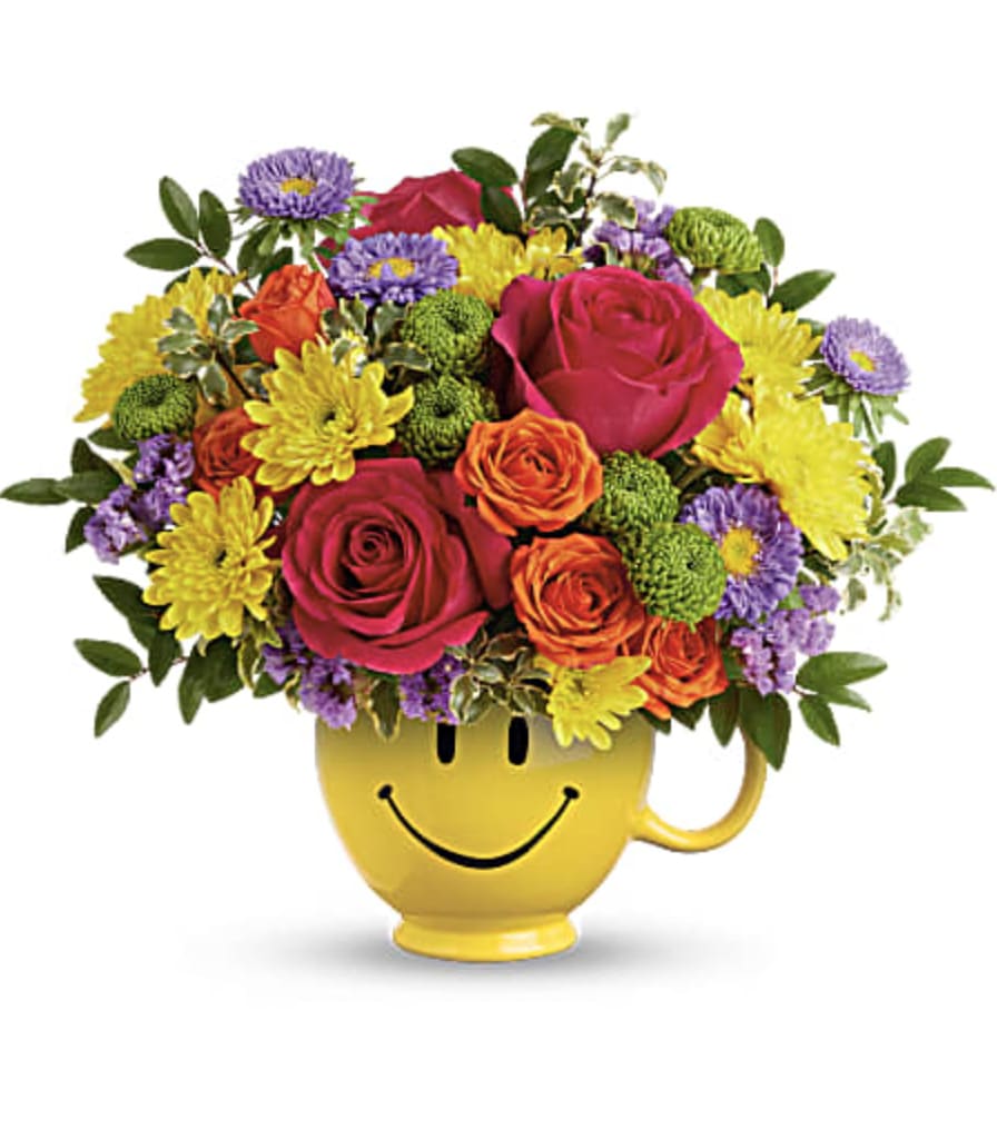 Colorful bouquet in a yellow smiley-face mug